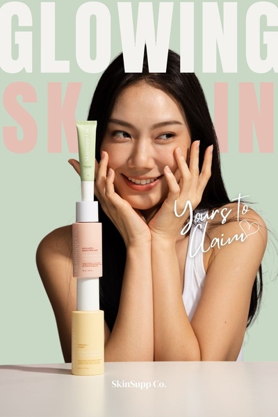 A vertical stack of skincare product containers presented by a smiling model, emphasizing a clean, aesthetic, and aspirational look.