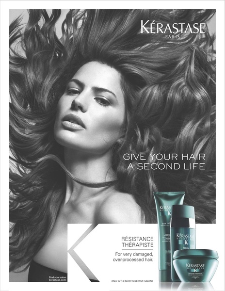 A high-contrast black and white hair serum advertisement featuring a model with voluminous hair, emphasizing the transformative effects of the product.