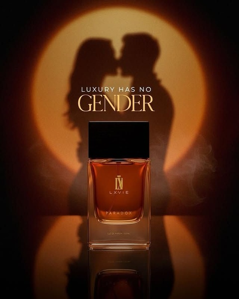 A high-end product photography shot of a perfume bottle against a circular warm backlight, featuring a silhouetted couple kissing in the center.