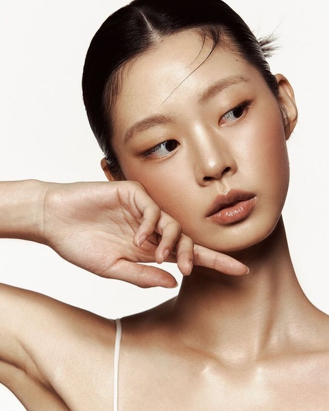 A close-up, high-resolution portrait showcasing flawless, dewy skin to emphasize product efficacy through a natural, clean aesthetic.