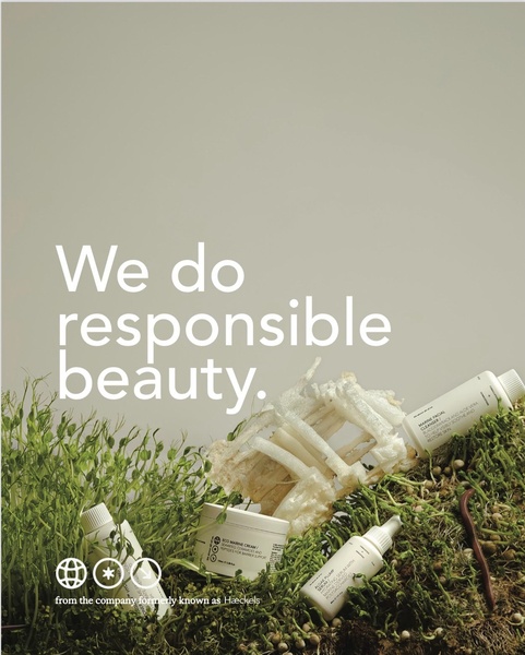 A minimalist, high-quality photograph showcasing skincare bottles nestled in live greenery, emphasizing a responsible and natural brand identity.