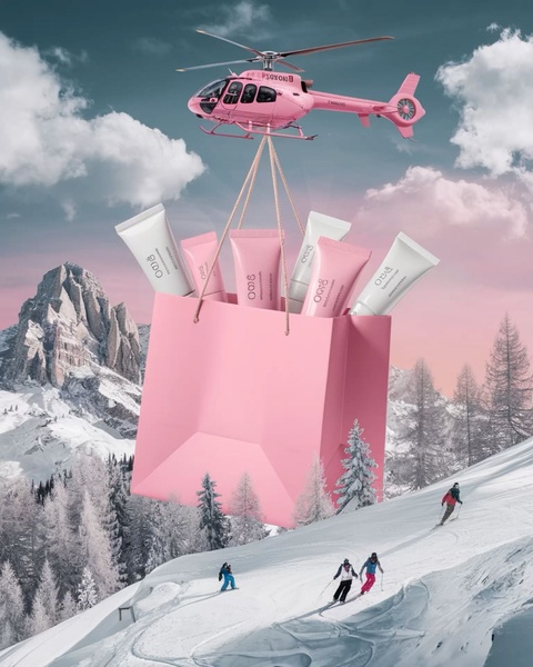 A surreal creative showing a pink helicopter air-lifting a bag of skincare products over a snowy mountain range, emphasizing luxury and premium distribution.