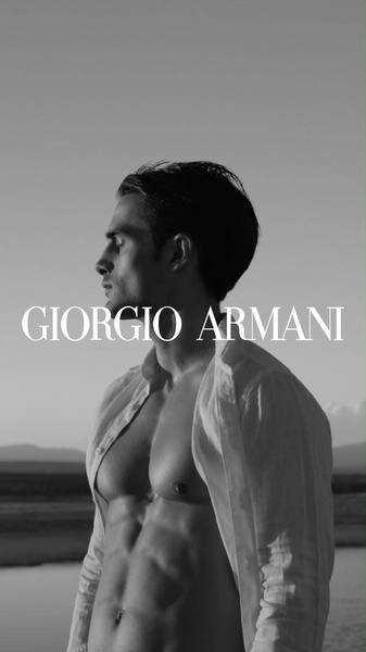 A high-contrast, black and white portrait of a model showcasing a fragrance with a clean, luxury aesthetic.