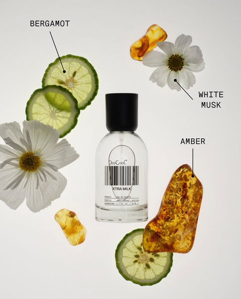 A minimalist, high-contrast product photography layout showcasing perfume ingredients alongside the bottle to emphasize the scent profile.