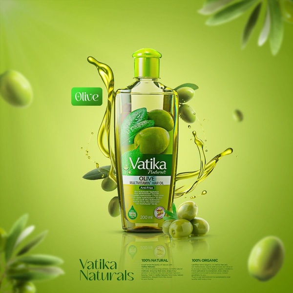 This ad creative features a 1:1 square format showcasing a bottle of Olive Multivitamin Hair Oil surrounded by liquid olive oil splashes and fresh olives, set against a vibrant green background.
