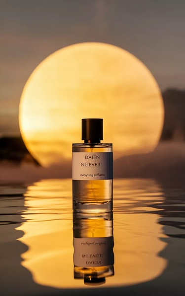 A sleek, high-end perfume bottle centered on a reflective surface against a massive golden moon backdrop.