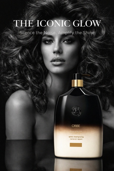 A luxury hair conditioner bottle sits in the foreground with a dramatic, high-contrast portrait of a woman with voluminous hair in the background.