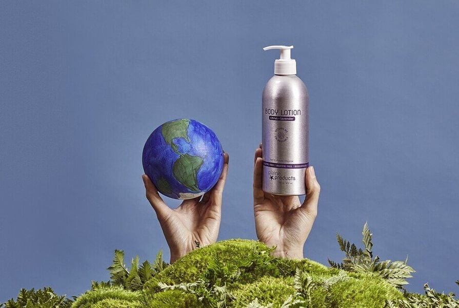 A split-screen composition featuring a body lotion bottle and a globe being held against a natural mossy foreground and blue background.