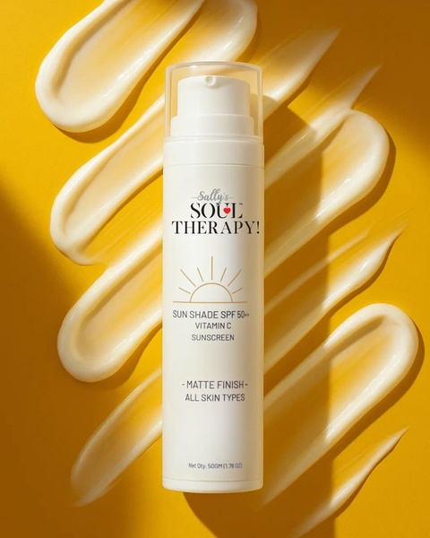 A high-contrast hero shot of a sunscreen bottle placed over repeating cream smears on a vibrant yellow background.