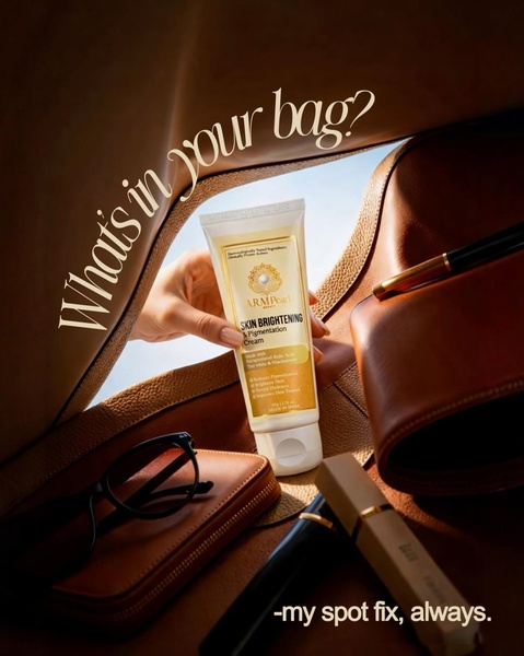 A close-up, lifestyle-oriented shot featuring a tube of skincare cream held inside an open leather bag, framed as an essential daily item.