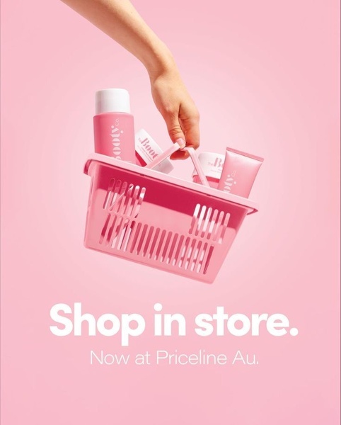 A clean, minimalist product hero shot of skincare items in a pink shopping basket, highlighting retail availability.