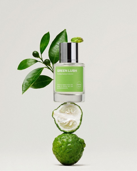 A high-end, floating composition showcasing a perfume bottle balanced with citrus fruits and fresh leaves against a clean backdrop.