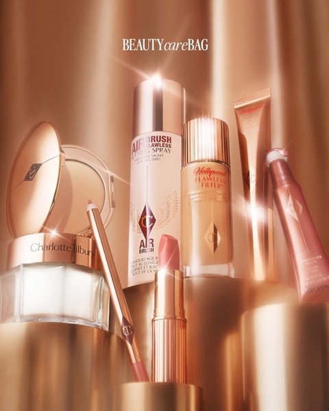 A high-end studio photograph featuring a collection of branded cosmetic products arranged on pedestals with elegant silk-like lighting.