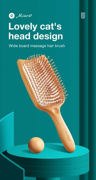 A high-quality studio shot of a wooden massage hair brush with a cat-shaped head, presented on a minimalist platform.