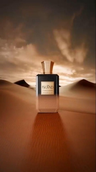 A high-end studio-style product shot featuring a perfume bottle centered in a stylized desert landscape with dramatic sunset lighting.