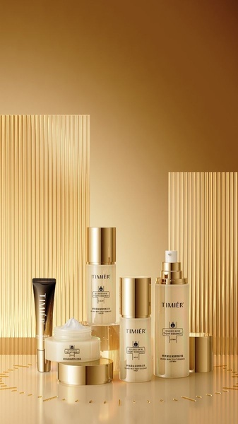 A high-end, studio-lit display of the Timier skin serum product range, featuring a cohesive gold and amber color palette.