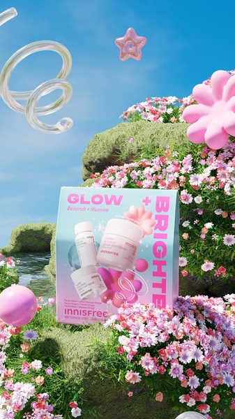 A high-conversion product hero ad for a skincare gift set, utilizing a dreamy, surreal 3D garden environment to emphasize a bright and glowing brand identity.