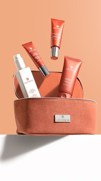 This creative showcases a four-piece skincare set levitating above a matching carrying case, emphasizing a high-end, editorial aesthetic.