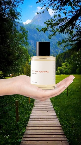 A perfume bottle held in an open palm against a scenic mountain path, emphasizing natural elements and brand elegance.