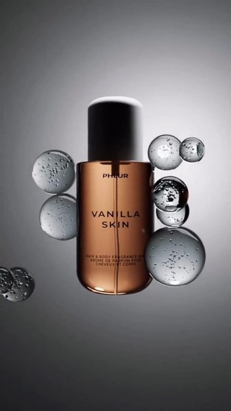 A high-end studio shot of a perfume bottle suspended in a fluid, airy environment with surrounding light spheres.