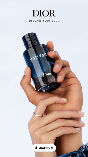 A close-up aesthetic shot featuring a bottle of perfume held by hands in a serene, bright environment, focusing on product purity and brand recognition.