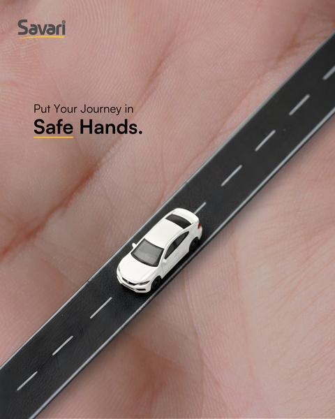 A creative visual concept showing a miniature car traveling along a road placed on a human palm, symbolizing safety and personal care.