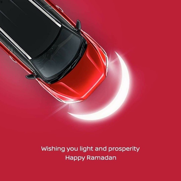 A high-angle studio shot of a red luxury vehicle paired with a minimalist moon icon to convey seasonal messaging and brand sophistication.
