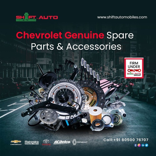 A high-density product arrangement showcasing various automotive spare parts for Chevrolet and other brands, set against a blurred urban street background.