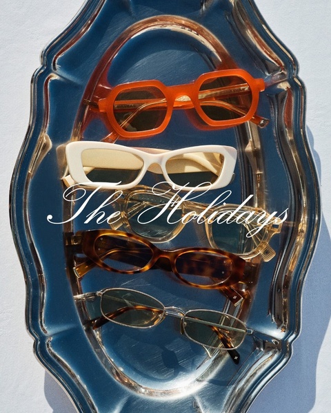 A stylish flat lay of five distinct sunglasses arranged on a polished silver tray, capturing a luxury seasonal mood.