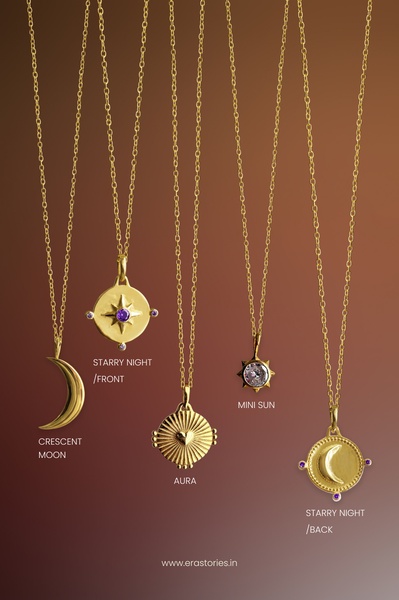 A clean, studio-lit showcase of multiple necklace designs including Crescent Moon, Starry Night, and Mini Sun styles on a soft gradient background.