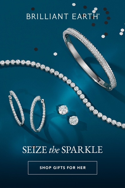 A high-end jewelry arrangement featuring a diamond tennis bracelet, bangle, and stud earrings against a deep teal backdrop with shimmering light effects.