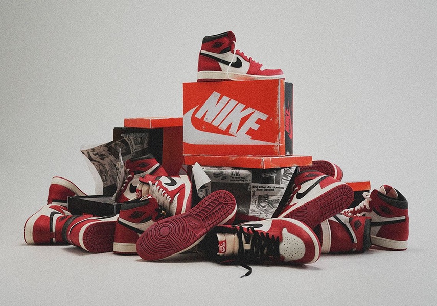 A high-impact, symmetrical product hero shot featuring a branded shoebox topped with multiple pairs of red-and-white running shoes, utilizing a vintage aesthetic.