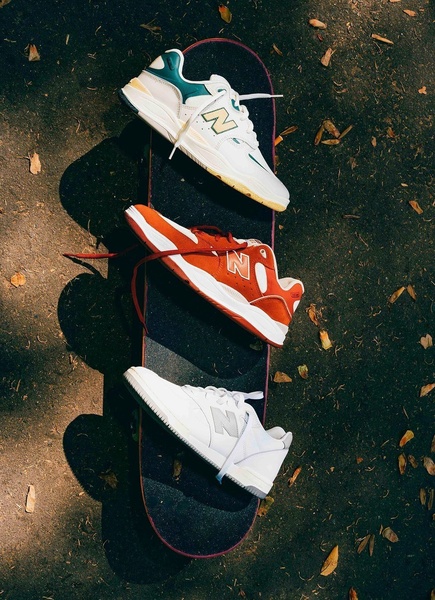 A vertical-ratio creative featuring three distinct sneaker colorways arranged symmetrically on a skateboard against an asphalt background.