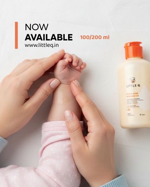 This ad creative features a high-angle, close-up shot of a parent applying massage oil to a baby's hand, highlighting the product with a minimalist aesthetic.