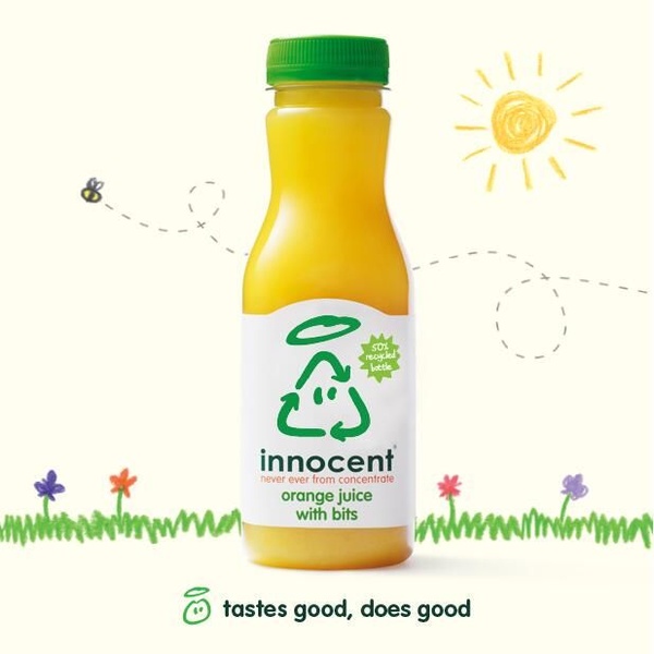 A high-contrast, clean studio shot of an orange juice bottle adorned with simple, childlike hand-drawn sketches of the sun, grass, and bees to convey freshness.