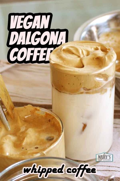 A visually striking hero shot of whipped coffee in a glass, highlighting the contrast between the thick coffee topping and the dairy-free milk base.