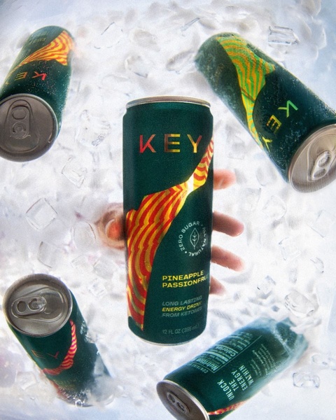 A high-fidelity hero shot featuring multiple cans of an energy drink submerged in fresh ice, emphasizing a cooling, refreshing experience.