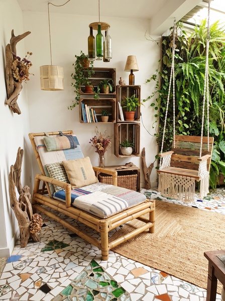 A high-quality lifestyle shot featuring a bamboo lounge chair, a macrame swing, and mosaic flooring, emphasizing a natural and calm indoor atmosphere.