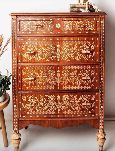 A high-resolution, static studio shot of a hand-crafted wooden chest with intricate bone inlay patterns, presented in a portrait ratio for mobile feeds.