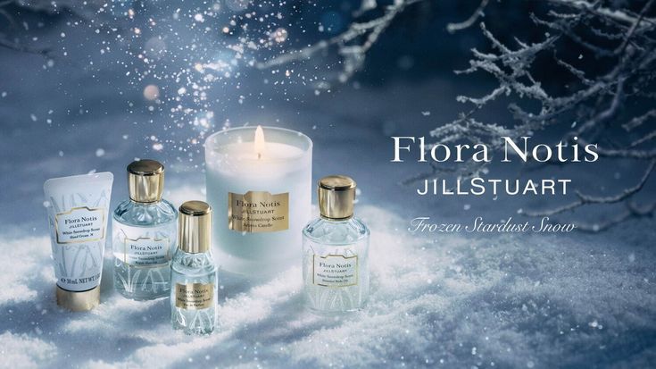 This creative showcases a luxury candle and fragrance set arranged in a snowy forest setting to convey a premium, cold-weather seasonal aesthetic.