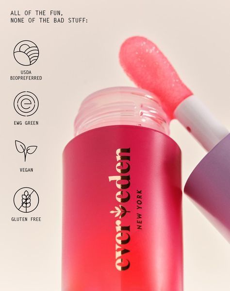 A close-up, high-saturation product shot of a lip gloss applicator highlighting core brand values through icon-based certification call-outs.