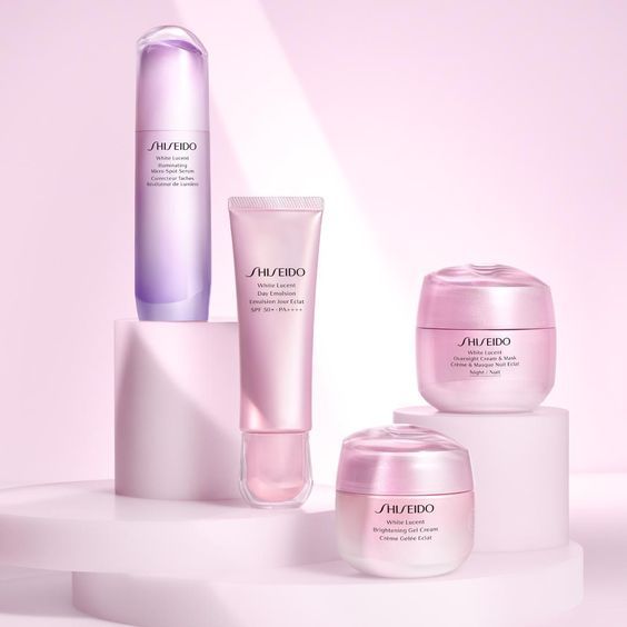 This creative showcases a complete skincare product line arranged on geometric platforms against a soft pastel background to emphasize a luxury, professional aesthetic.