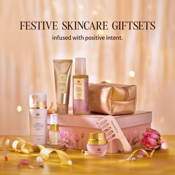 A high-end, studio-lit hero shot of a skincare product collection arranged as a festive gift set, emphasizing gold accents and premium packaging.