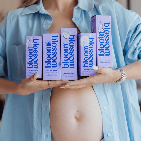 This 1:1 square creative features a close-up of a pregnant individual holding multiple branded skincare products, emphasizing product range and ease of use.