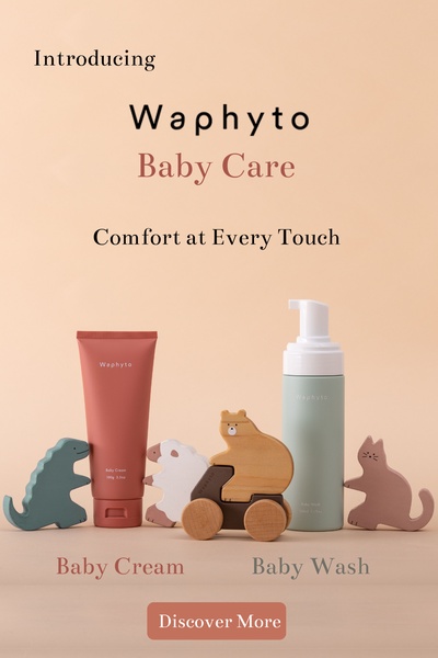 A high-quality studio product shot featuring baby cream and baby wash surrounded by playful, minimalist wooden animal toys on a soft peach background.
