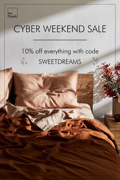 A clean, minimalist product photograph featuring layered linen bedding in warm, neutral tones to announce a seasonal sale event.