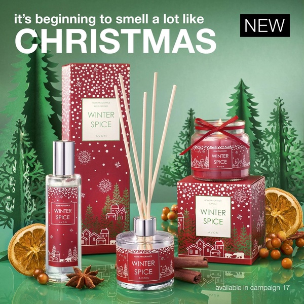 A high-contrast, seasonal product hero shot featuring home fragrance items surrounded by holiday decor like cinnamon and dried oranges.