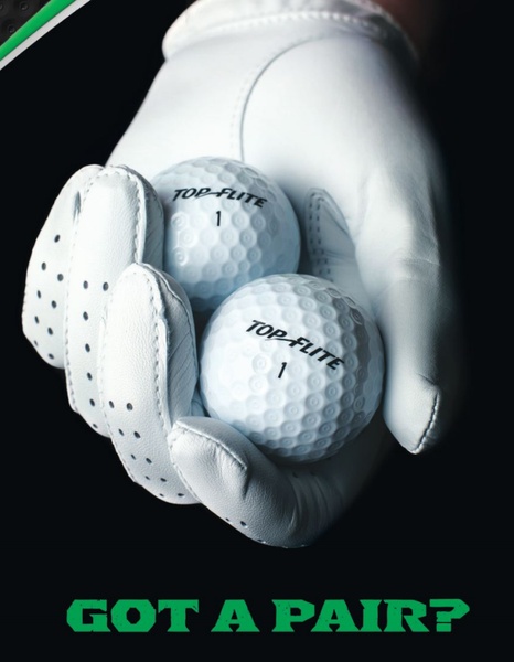 This creative features a close-up, high-contrast shot of a hand wearing a white leather golf glove holding two branded golf balls against a pitch-black background.
