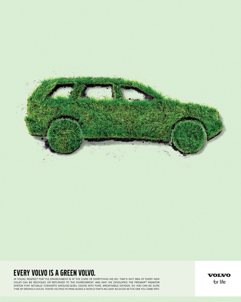 A minimalist ad featuring a Volvo silhouette constructed entirely from green grass against a soft, light-green background, emphasizing environmental friendliness.