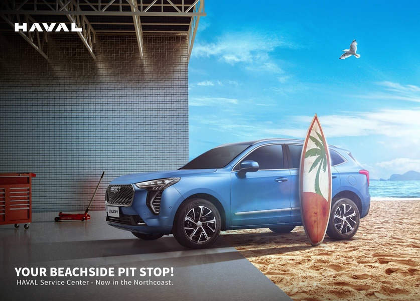 An SUV parked on a beach with a surfboard leaning against it, creating an aspirational lifestyle brand image.